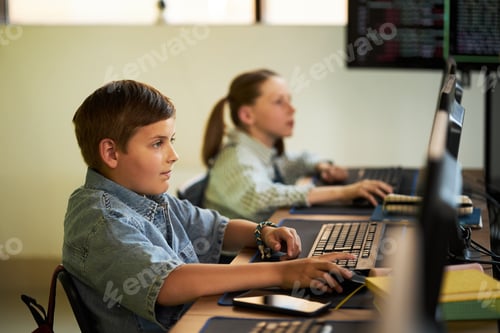 Preview: Caucasian Boy and Girl Learning Computer Programming in Classroom Setting