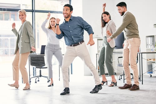 Preview: Full length shot of a diverse group of businesspeople standing together and dancing in the office