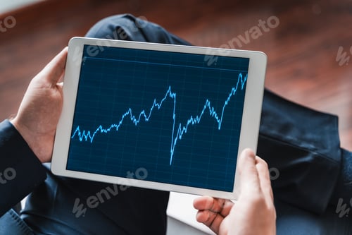 Preview: Businessman, investor,trader analyzing,looking at chart of stock prices in tablet. CEO,general manag