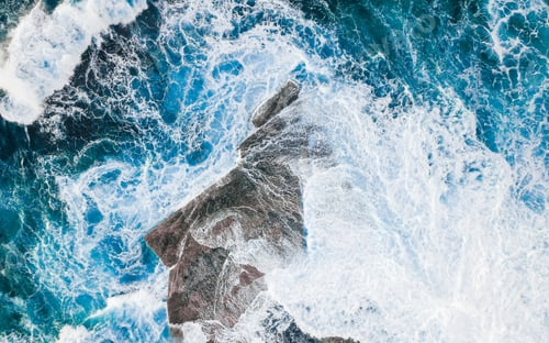 Preview: Swirls and texture as waves break over a rock platform