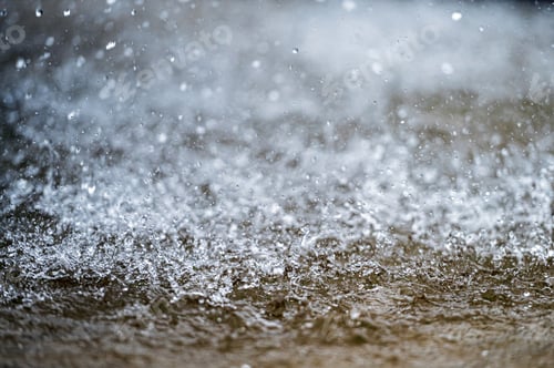 Preview: Water splashes on a blurred background. Drops of water fly in the air. Selective focus