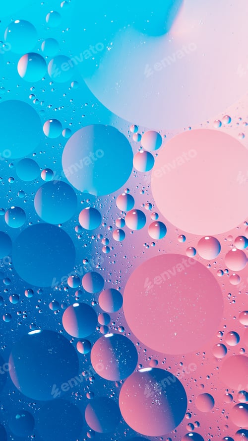 Preview: oil with bubbles on vibrant blue and pink background. Abstract background.