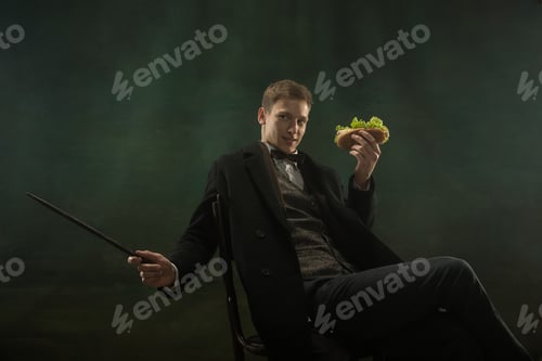 Preview: Young man in art action isolated on dark green background. Retro style, comparison of eras concept