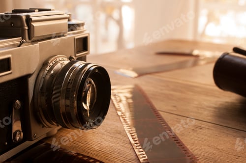 Preview: Vintage Film Camera with Film Strip on Table