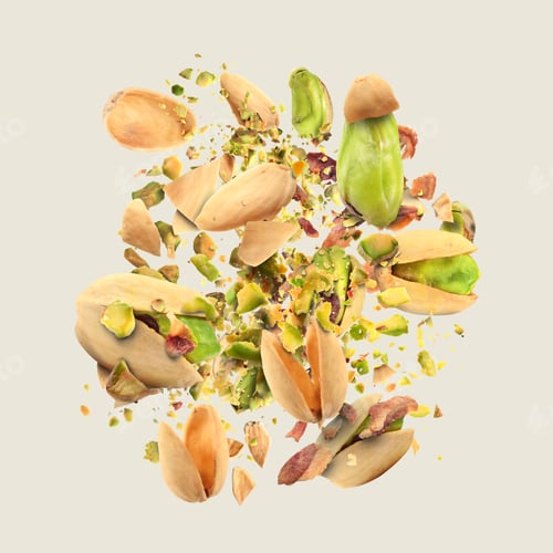 Preview: Tasty pistachios with cracked nut shells in air on light grey background
