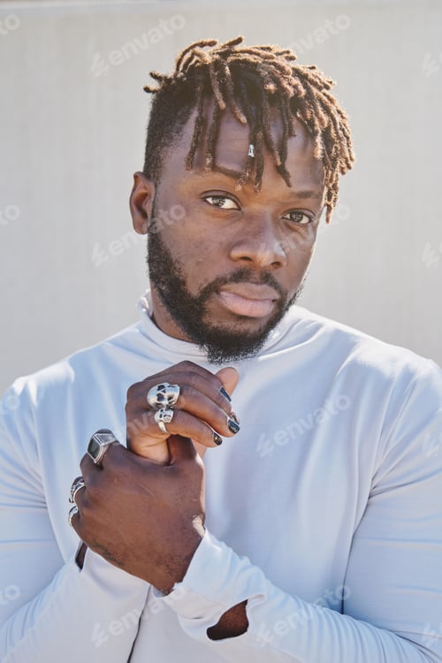 Preview: Serious stylish black man touching wrist