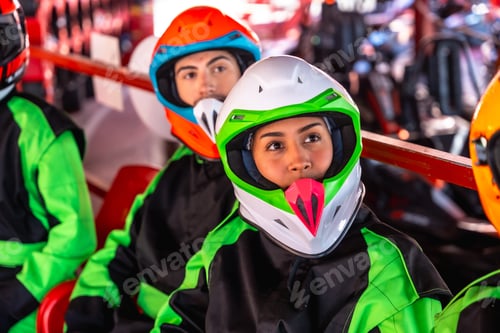 Preview: Racers wearing helmets preparing for go kart competition