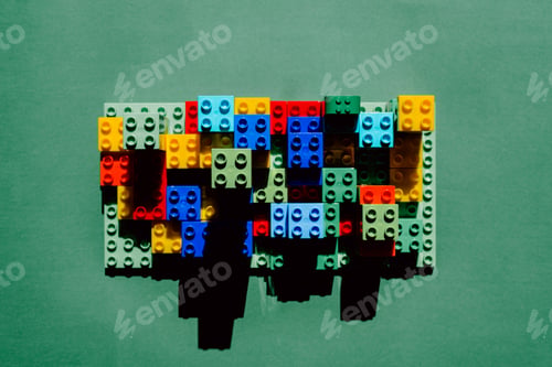 Preview: A structure with colored plastic blocks with harsh shadows in the sun.