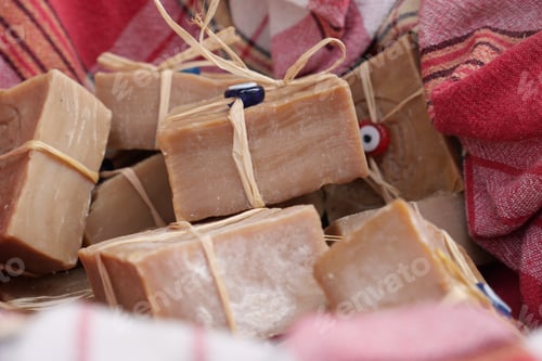 Preview: Discover beautiful handmade organic soap bars presented in a wicker basket with colorful fabrics