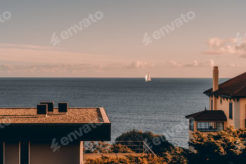 Preview: Sailboat on calm ocean at sunset