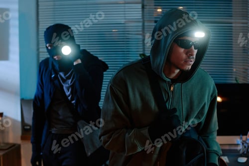 Preview: Young Adult Asian Man Stealing Office Equipment during Nighttime Burglary