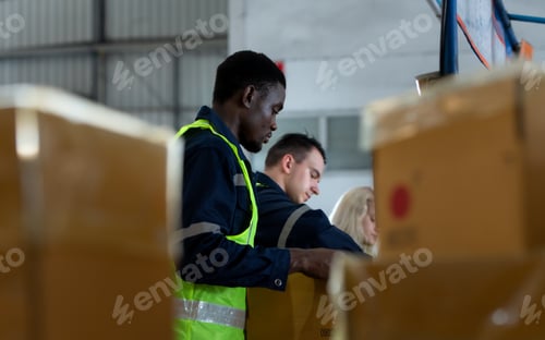 Preview: Group of worker in auto parts warehouse Packing small parts in boxes