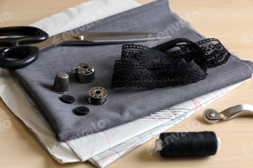 Preview: Set of sewing supplies and accessories with fabric on wooden table