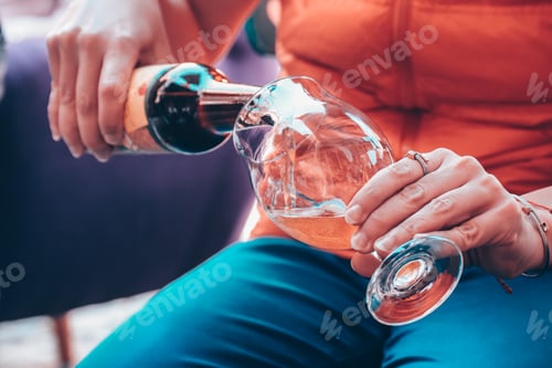 Preview: Woman pouring glass of beer