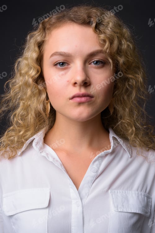 Preview: Face of young beautiful businesswoman with curly blond hair