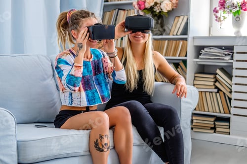 Preview: Two females having fun with virtual reality glasses.