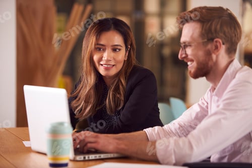 Preview: Business Colleagues With Laptop Having Informal Meeting Around Table In Office Coffee Shop