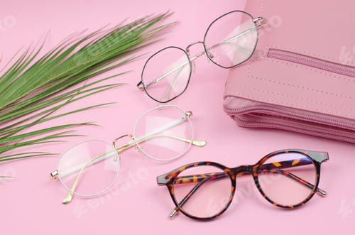 Preview: Stylish women's glasses on a colored background with palm leaves