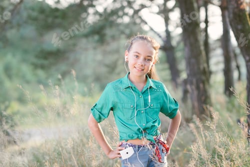 Preview: Little cute girl spends his free time outdoors in the woods.
