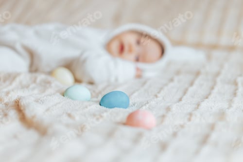 Preview: Infant Sleeping with Painted Easter Eggs on Blanket