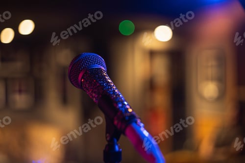 Preview: Closeup shot of a microphone on a blurred background with bokeh lights