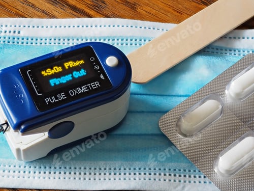 Preview: Closeup shot of a pulse oximeter with pills and a medical protective face mask on the table