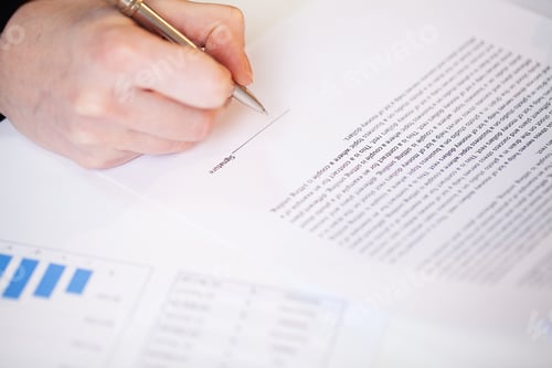 Preview: Man signs a contract at a desk in a company office