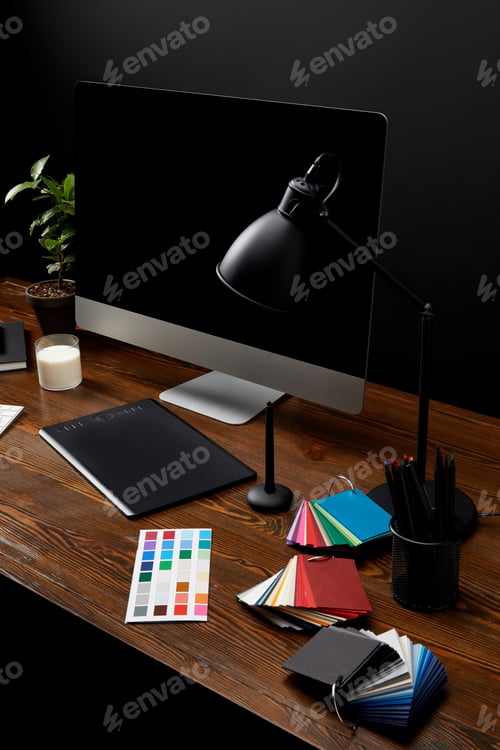 Preview: close up view of graphic designer workplace with colorful pallet, graphic tablet, blank computer