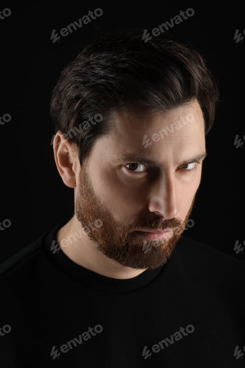 Preview: Evil eye. Man with scary eyes on black background
