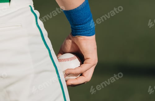 Preview: Close up of pro baseball playing holding a baseball about to pitch