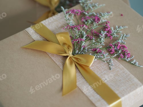Preview: Gift Box with Ribbon and Flowers Close Up