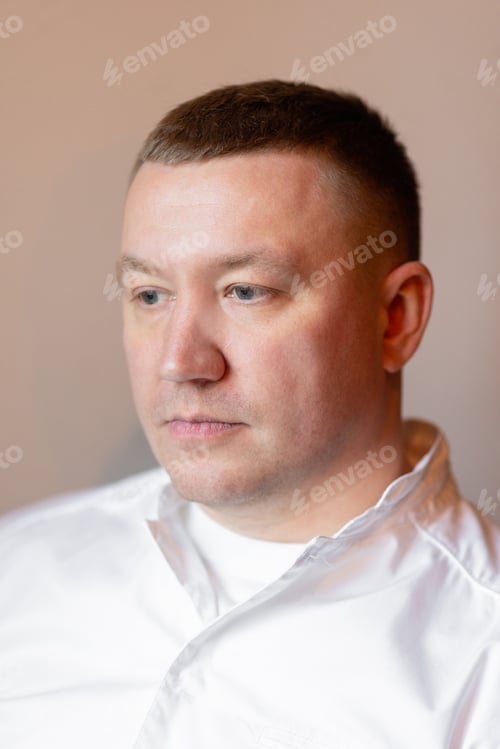 Preview: Sad young man on grey background, male loneliness, suffering breakup depression boredom