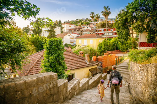 Preview: A man and his little daughter walking down a stone stairway in town Herceg Novi, Montenegro