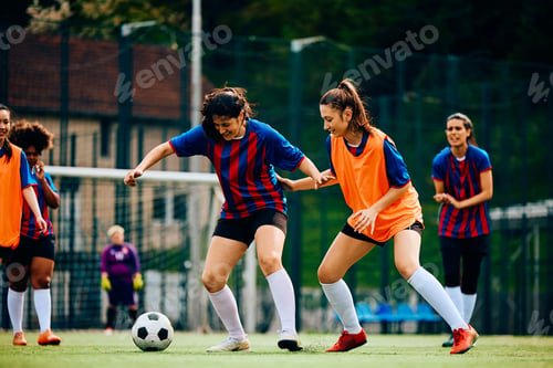 Preview: Female players in action during practice on soccer pitch.