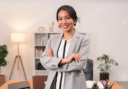 Preview: Executive Asian businesswoman smiling and crossed arms in office.