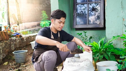 Preview: Asian man Prepare a place for planting with pot and soil