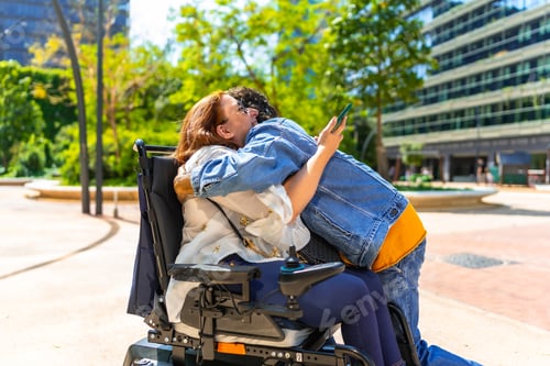 Preview: Woman in wheelchair hugging friend in urban park