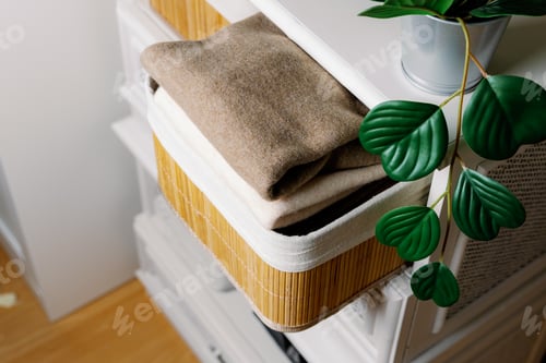 Preview: Stylish wool sweaters in a bamboo box in the closet.
