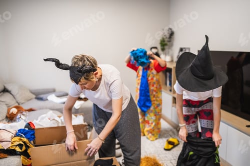 Preview: Mother and children trying on carnival costumes at home