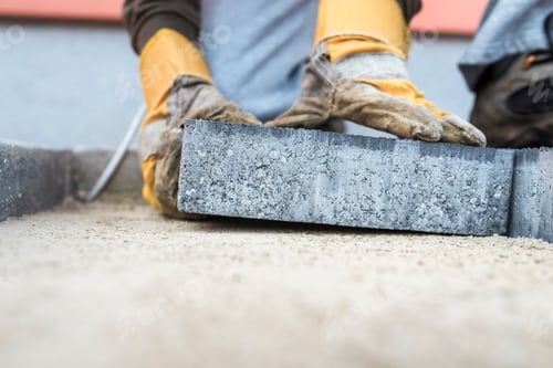 Preview: Building contractor laying a paving slab