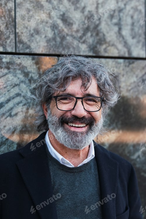 Preview: Happy handsome mature businessman looking at camera