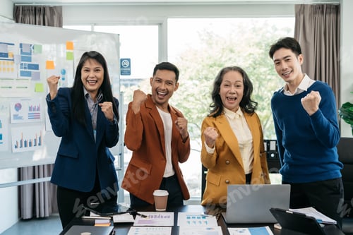 Preview: Successful business team, excited young people Keeping up arms and showing positive emotions