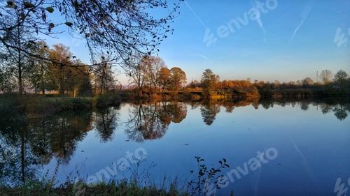 Preview: Calm Lake Reflecting Autumn Trees and Sky
