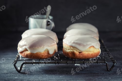Preview: Yummy donuts with powdered sugar on cooling grate