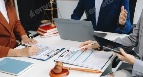 Preview: business people and lawyers discussing contract papers sitting at the table.