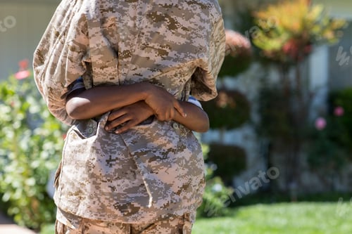 Preview: Cropped rear view of female soldier hugging son on homecoming