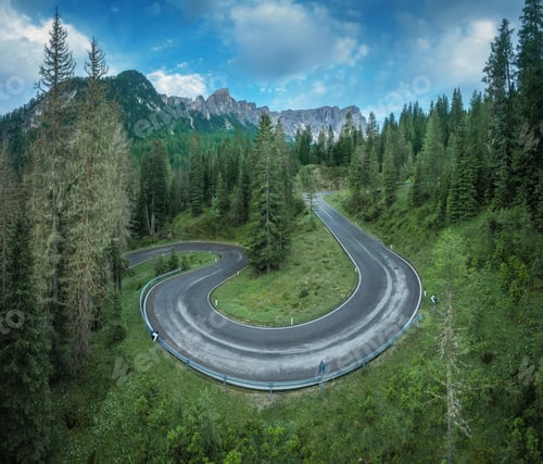 Preview: Aerial view of winding road, green forest in mountains in summer