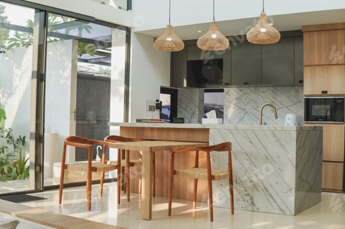 Preview: A kitchen with a marble countertop and large island. The kitchen is well lit and has a modern feel.