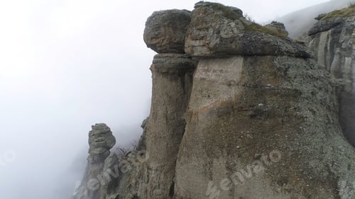Preview: Majestical mountains in clouds with yellow, autumn trees. Shot. Landscape with beautiful high rocks
