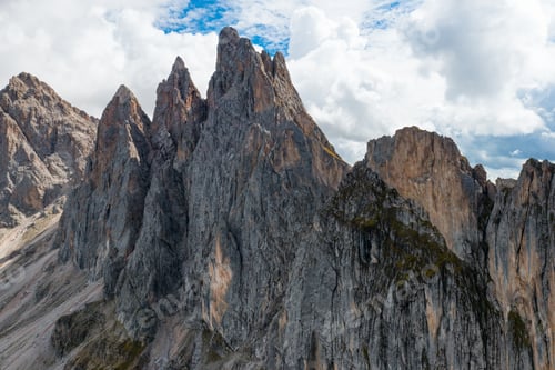 Preview: Rocky peak of Seceda mountain range against cloudy sky